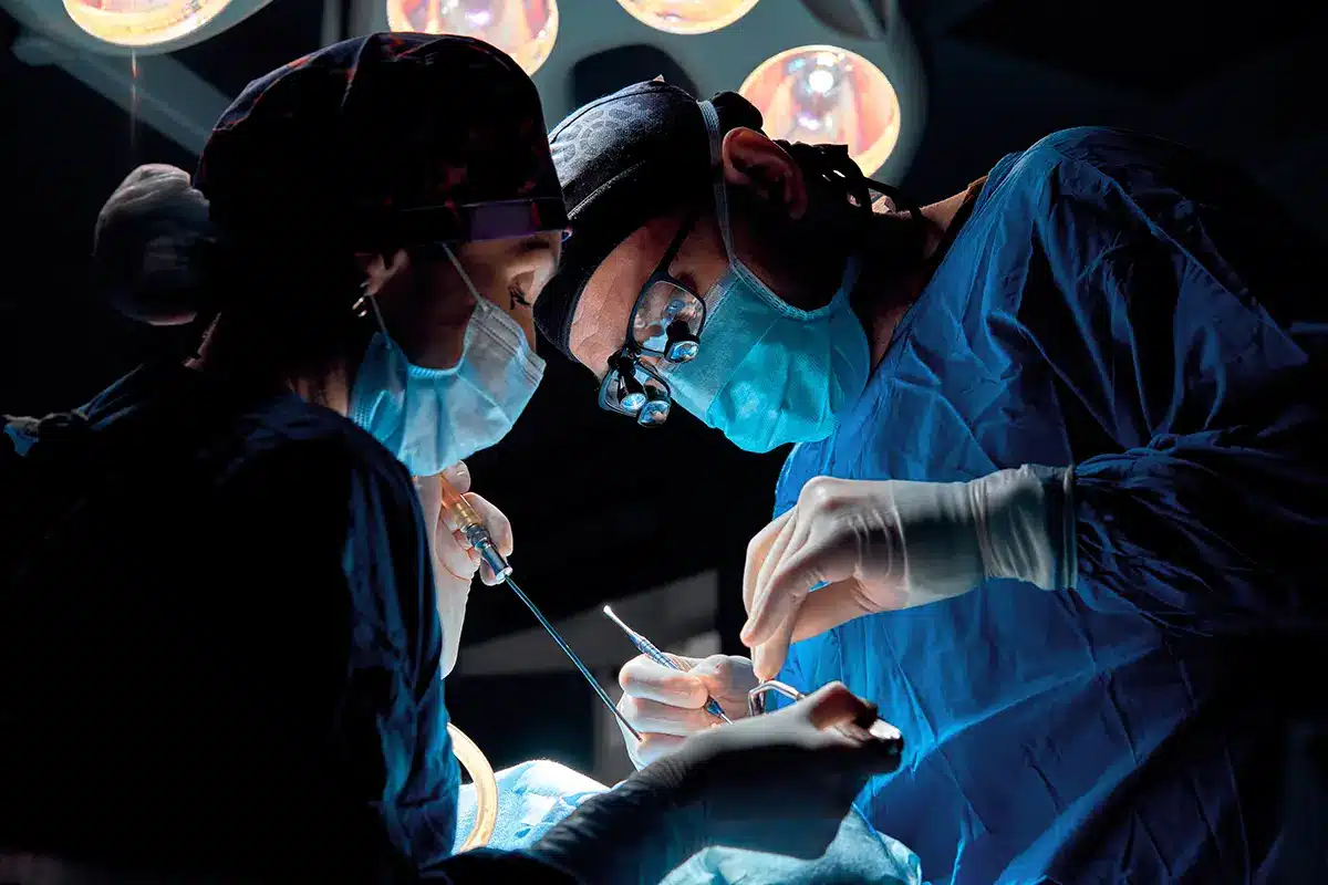 surgeon in mask wearing loupes during medical procadure surgeon in mask wearing loupes during medical procadure