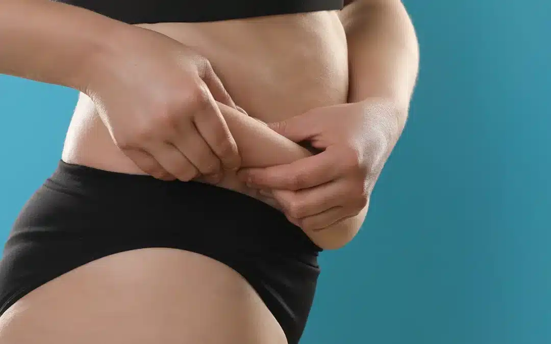 woman touching love handles