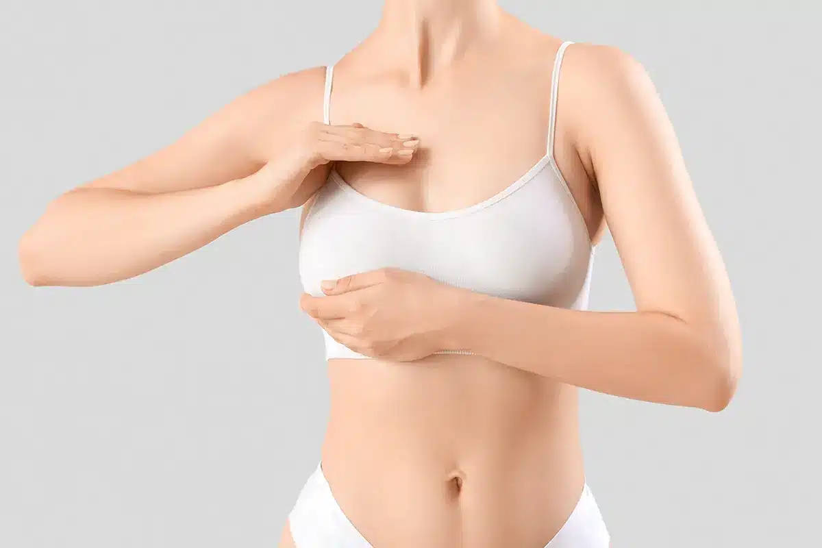 young woman touching her breast young woman touching her breast